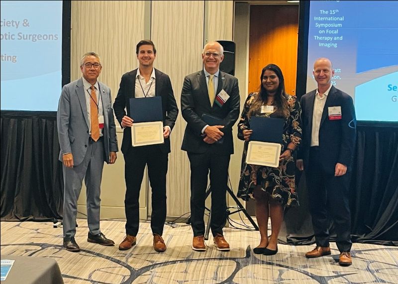 Duke robotics fellow Brian Calio, MD, accepts his best poster award for the SURS session.