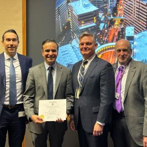 Dr. Khera holding his honorary DYSURIA certificate along with Aaron Lentz, MD (Director of Men’s Health), Drew Peterson MD, MPH (Vice Chair of Education), and Glenn Preminger, MD (Chair of CME Committee).