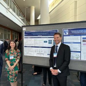 People standing in front of a research poster